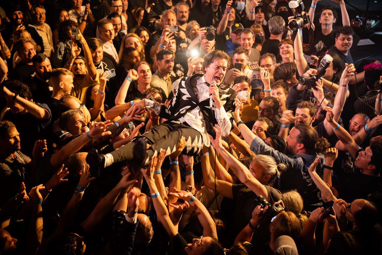 Lead singer of The Hives crowd surfing