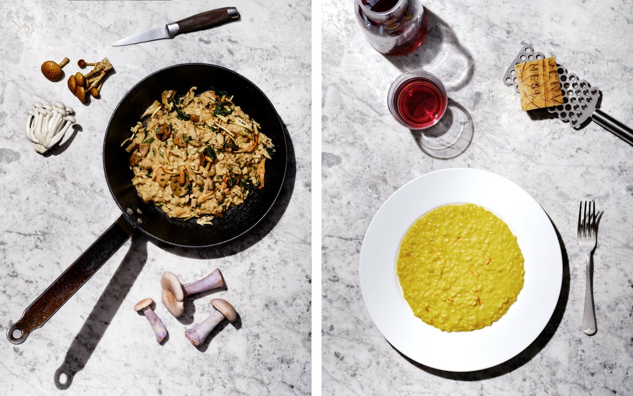 Top view of pan of mushroom risotto on marble counter with knife and fresh mushrooms / Top view of white plate of saffron risotto on marble counter with grater and cheese and glass and carafe of red wine