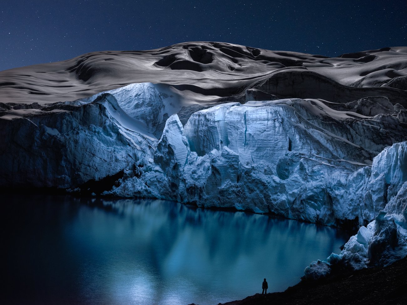 Circle of light above arid salt flats at night