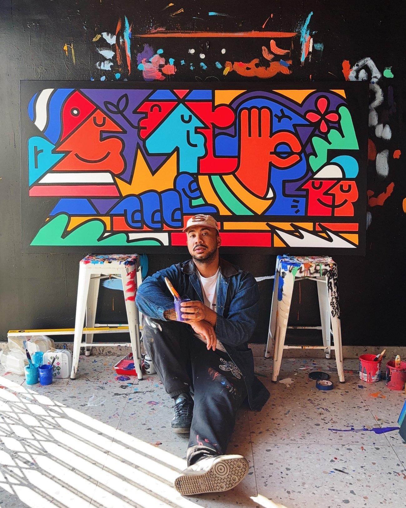 Studio work by Russell Abrahams showing colorful painted illustrations