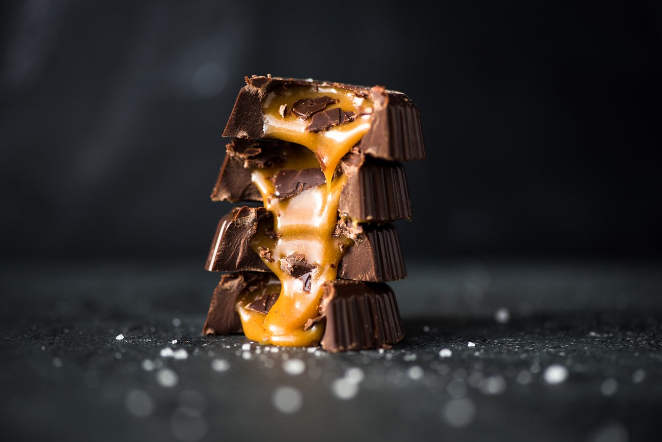 Side view of four stacked bitten caramel chocolates