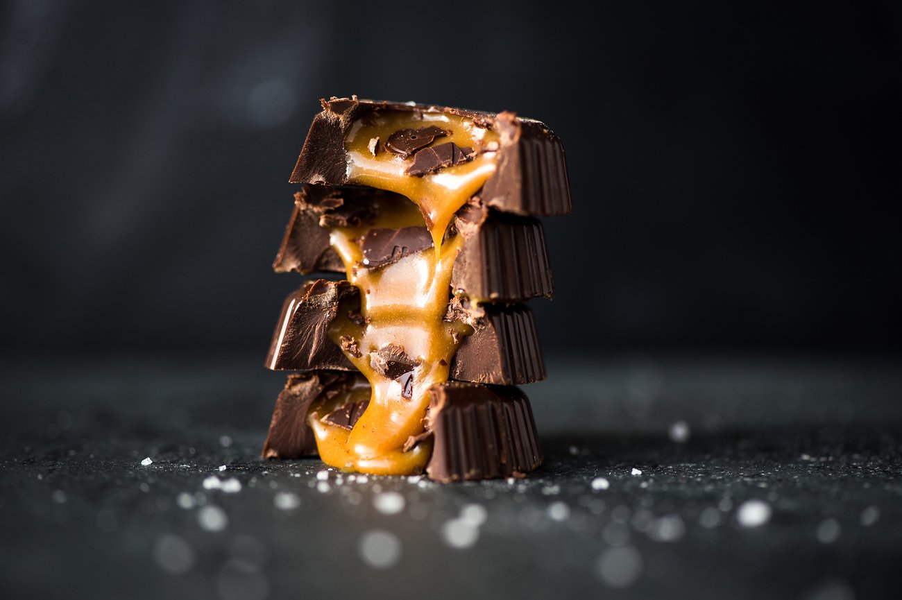 Side view of four stacked bitten caramel chocolates